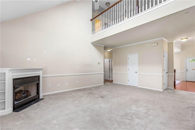 4012 Chianti Way, Greensboro, NC 27410 - unfurnished living room featuring carpet flooring, a high ceiling, baseboards, a fireplace with flush hearth, and ornamental molding