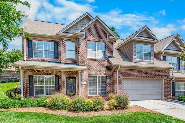 4012 Chianti Way, Greensboro, NC 27410 - view of front of home featuring concrete driveway, brick siding, an attached garage, and a shingled roof