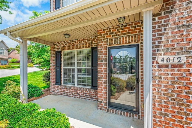 4012 Chianti Way, Greensboro, NC 27410 - doorway to property with brick siding and covered porch