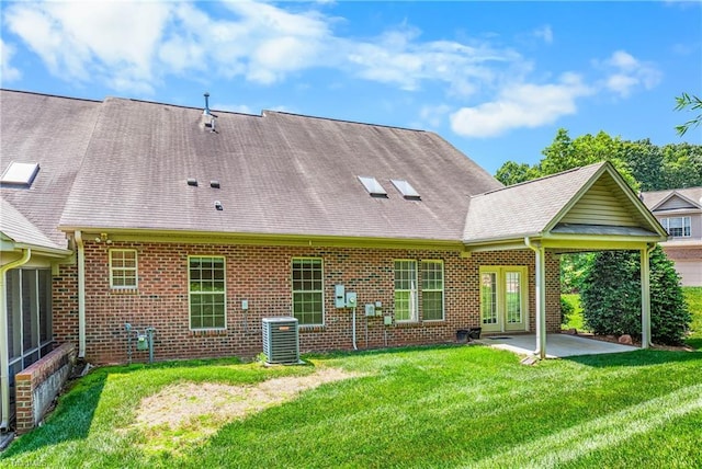 4012 Chianti Way, Greensboro, NC 27410 - rear view of house with a patio, a yard, central air condition unit, and brick siding