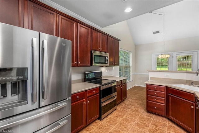 4012 Chianti Way, Greensboro, NC 27410 - kitchen with appliances with stainless steel finishes, a sink, vaulted ceiling, light countertops, and hanging light fixtures