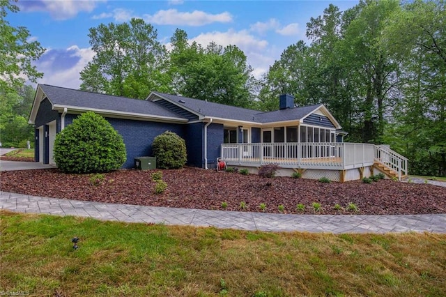 104 Shawnee Cir, Lexington, NC 27295 - ranch-style home featuring a deck, an attached garage, a chimney, and a sunroom