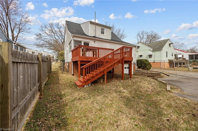 back of house featuring stairs, a yard, fence, and a wooden deck