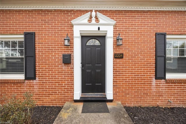 property entrance with brick siding