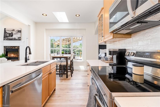 2264 Loflin Farlow Ln, Sophia, NC 27350 - kitchen featuring stainless steel appliances, light wood-style flooring, decorative backsplash, light countertops, and recessed lighting