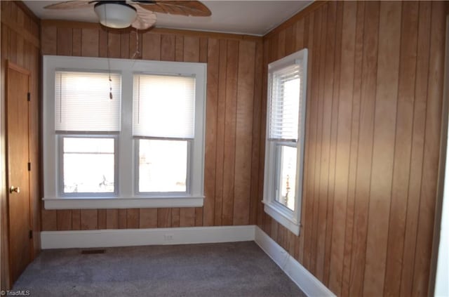 spare room with plenty of natural light, carpet, and a ceiling fan