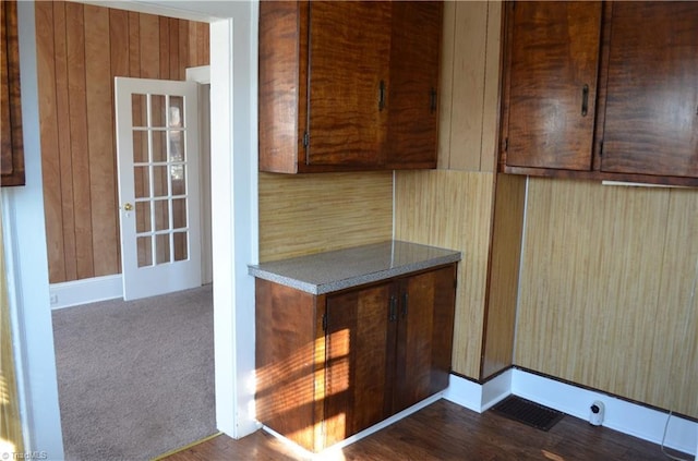 kitchen featuring visible vents and dark carpet