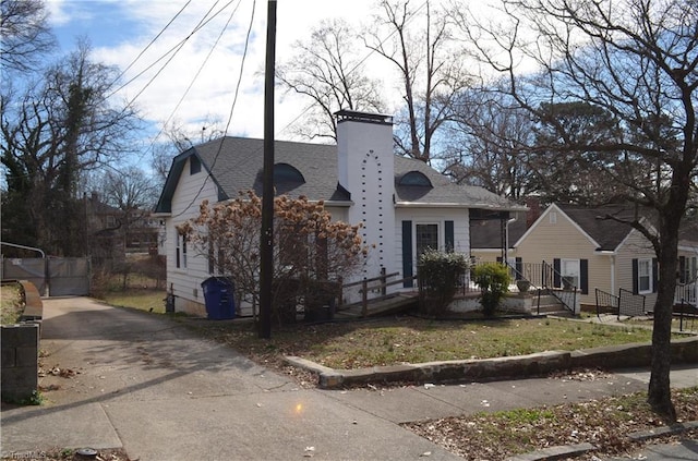 bungalow with a shingled roof and a chimney