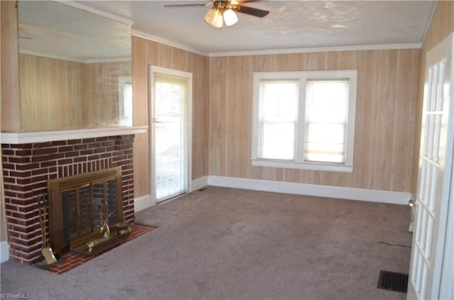 unfurnished living room featuring visible vents, carpet, crown molding, and baseboards