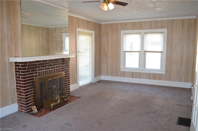 unfurnished living room featuring a fireplace, carpet, baseboards, and ornamental molding