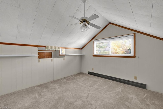 additional living space with a baseboard radiator, ceiling fan, lofted ceiling, and light colored carpet