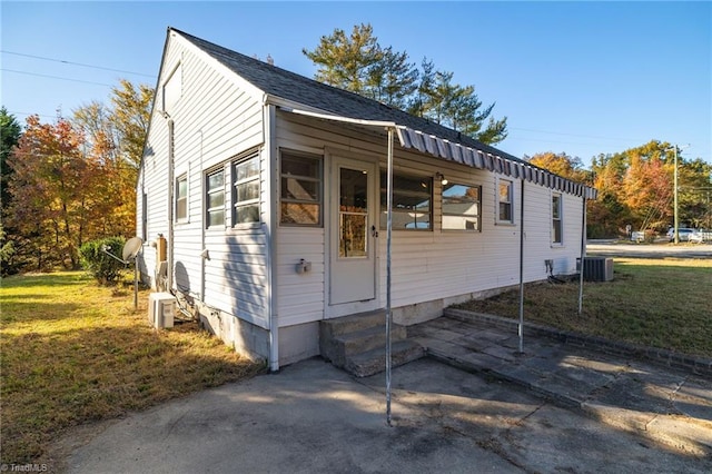 view of home's exterior featuring a yard and central air condition unit