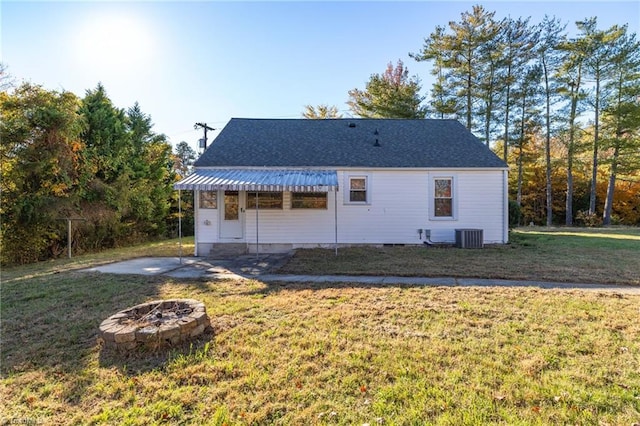 back of house with a yard, an outdoor fire pit, and cooling unit