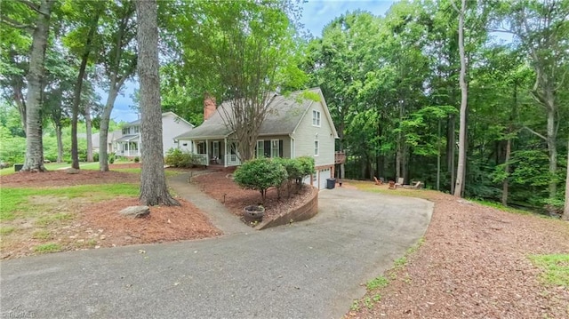 1721 Abbottsford Dr, Kernersville, NC 27284 - view of front of property with asphalt driveway, an attached garage, a chimney, and brick siding