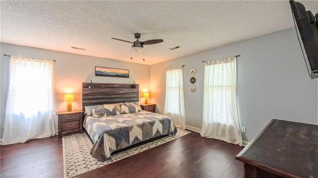 1721 Abbottsford Dr, Kernersville, NC 27284 - bedroom with dark wood-style floors, multiple windows, a textured ceiling, and a ceiling fan