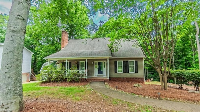1721 Abbottsford Dr, Kernersville, NC 27284 - view of front facade with covered porch, a chimney, and a shingled roof