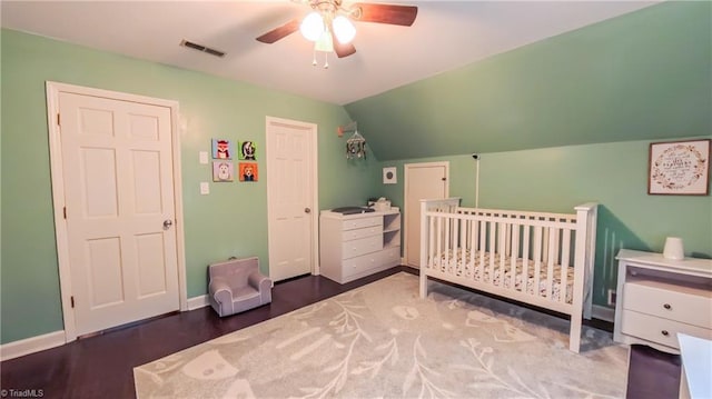1721 Abbottsford Dr, Kernersville, NC 27284 - bedroom featuring lofted ceiling, a crib, ceiling fan, and wood finished floors
