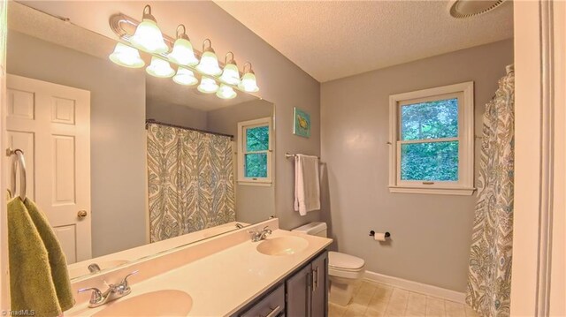 1721 Abbottsford Dr, Kernersville, NC 27284 - bathroom featuring double vanity, a textured ceiling, plenty of natural light, tile patterned floors, and a shower with shower curtain
