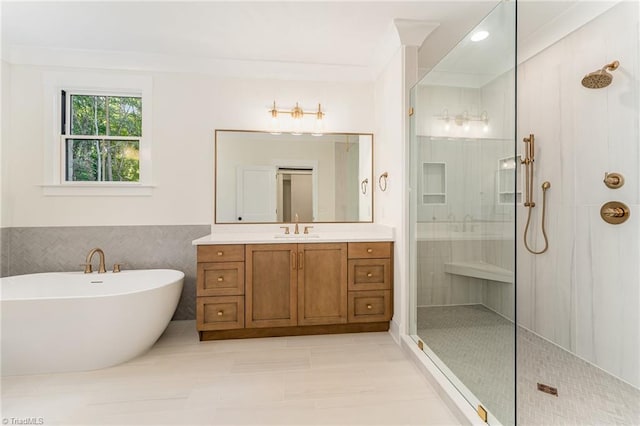 bathroom featuring plus walk in shower, vanity, tile walls, and tile patterned flooring