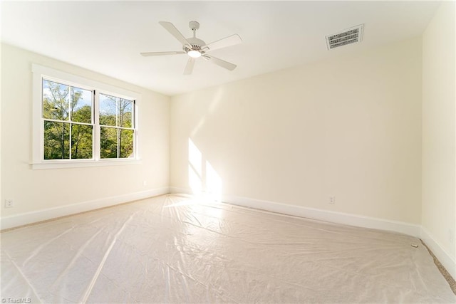 spare room with ceiling fan and light colored carpet