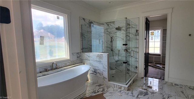 bathroom with shower with separate bathtub and plenty of natural light