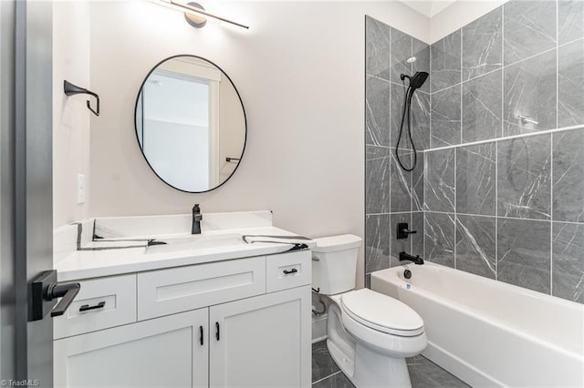 full bathroom featuring toilet, vanity, and tiled shower / bath