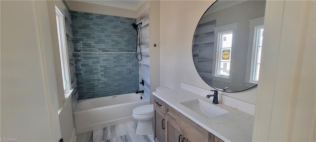 full bathroom with vanity, tiled shower / bath combo, and toilet