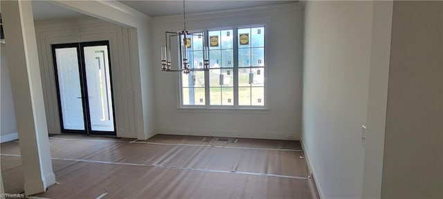 doorway to outside with an inviting chandelier, hardwood / wood-style flooring, and french doors