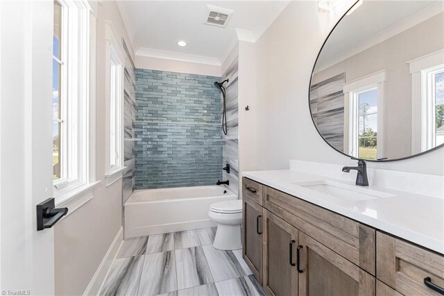 full bathroom with crown molding, tiled shower / bath combo, vanity, and toilet