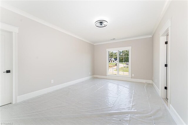 unfurnished room with ornamental molding