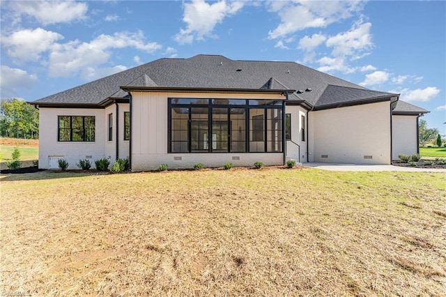 rear view of house with a patio area, a yard, and a sunroom