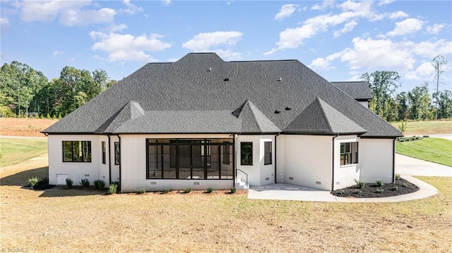 back of property with a yard and a patio area