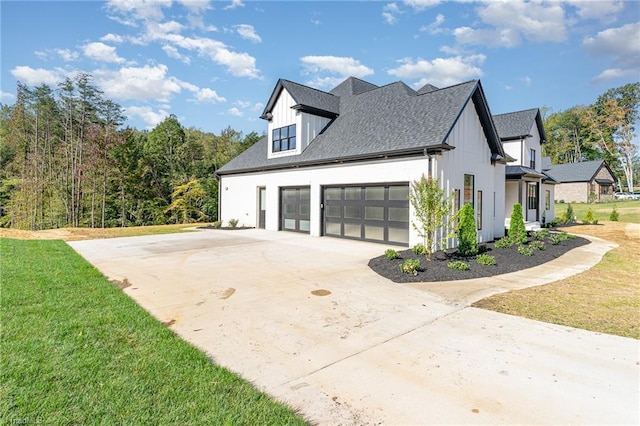 view of side of home with a yard and a garage