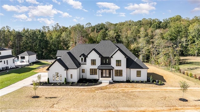 modern farmhouse style home with a front yard