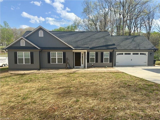 2968 Tobaccoville Rd, Tobaccoville, NC 27050 - view of front of property featuring a garage, roof with shingles, a front lawn, and concrete driveway