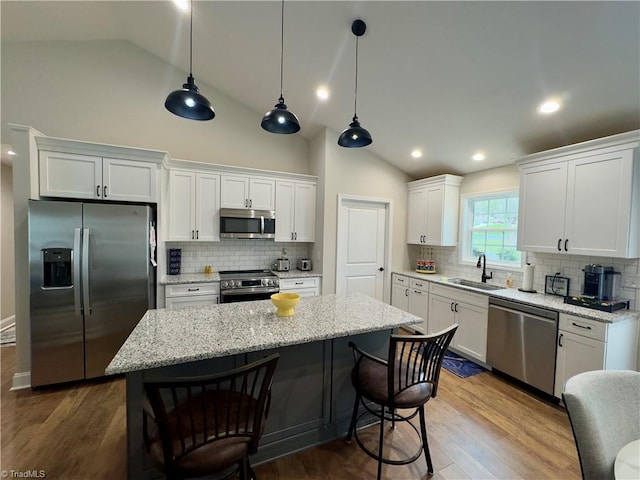2968 Tobaccoville Rd, Tobaccoville, NC 27050 - kitchen with white cabinets, a kitchen bar, a sink, and appliances with stainless steel finishes