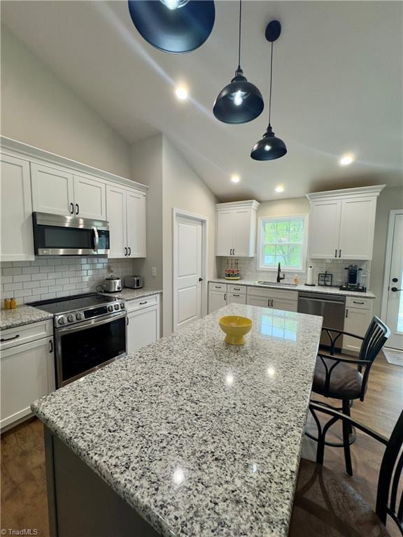 2968 Tobaccoville Rd, Tobaccoville, NC 27050 - kitchen featuring white cabinets, a sink, dark wood-style flooring, appliances with stainless steel finishes, and a kitchen island