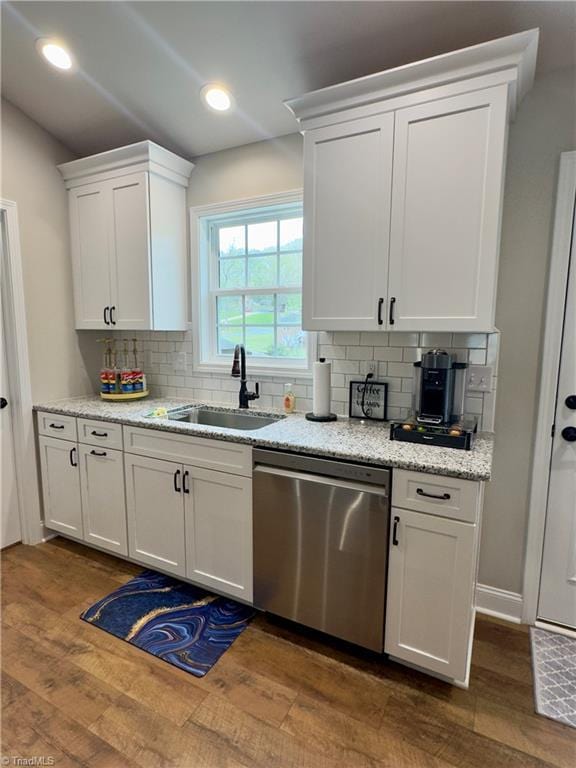 2968 Tobaccoville Rd, Tobaccoville, NC 27050 - kitchen with stainless steel dishwasher, dark wood-type flooring, white cabinetry, a sink, and decorative backsplash