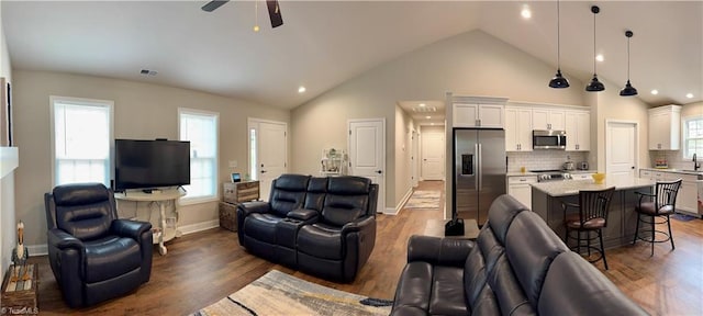 2968 Tobaccoville Rd, Tobaccoville, NC 27050 - living area with baseboards, visible vents, ceiling fan, high vaulted ceiling, and wood finished floors