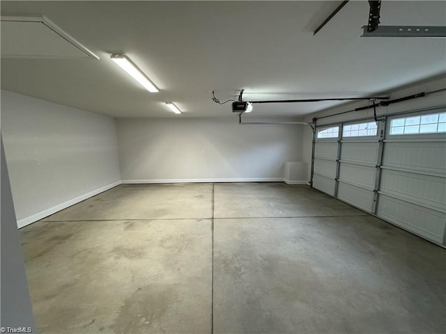 2968 Tobaccoville Rd, Tobaccoville, NC 27050 - garage with baseboards and a garage door opener