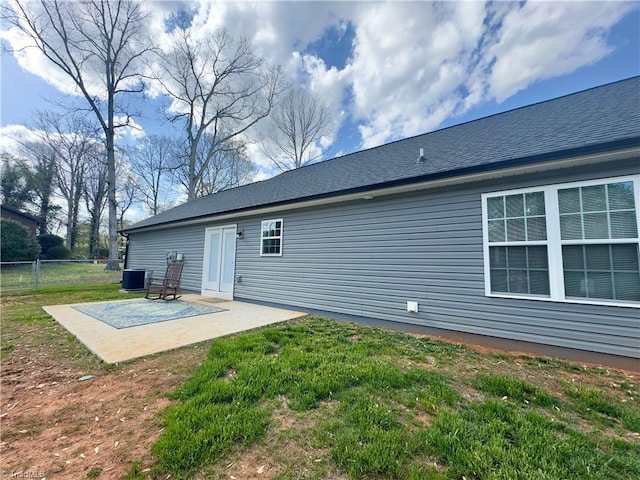 2968 Tobaccoville Rd, Tobaccoville, NC 27050 - rear view of house with a patio area, fence, and a lawn