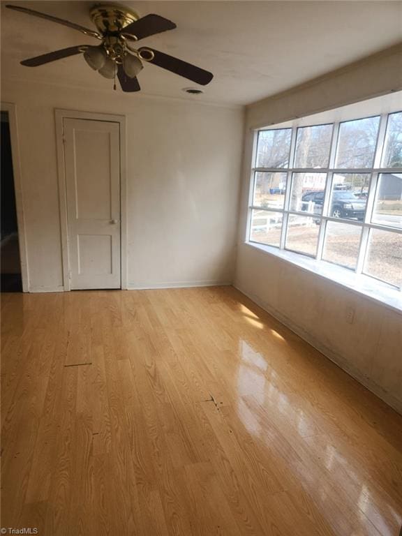 spare room with a wealth of natural light, visible vents, and light wood-type flooring