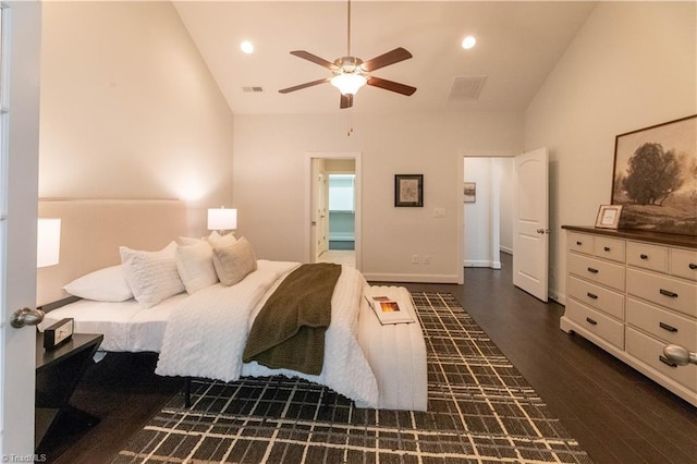 bedroom with a spacious closet, ceiling fan, dark hardwood / wood-style flooring, and vaulted ceiling