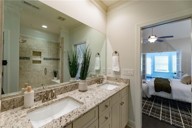 bathroom with ceiling fan, an enclosed shower, vanity, and crown molding