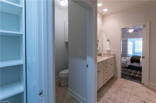 bathroom featuring toilet, ceiling fan, tile patterned flooring, ornamental molding, and vanity