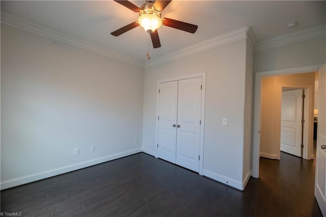 unfurnished bedroom with ceiling fan, a closet, dark hardwood / wood-style flooring, and ornamental molding