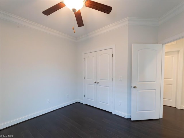 unfurnished bedroom with ceiling fan, a closet, dark hardwood / wood-style flooring, and ornamental molding