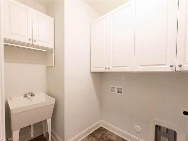 washroom featuring cabinets, electric dryer hookup, washer hookup, sink, and gas dryer hookup