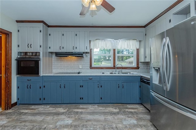 kitchen featuring backsplash, black appliances, sink, and light hardwood / wood-style floors