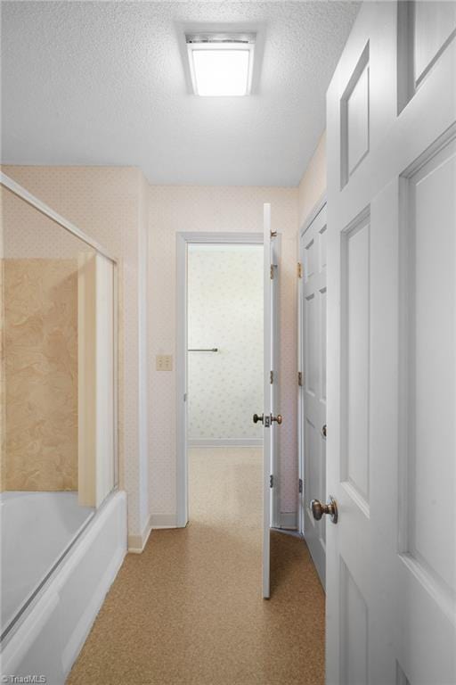 hallway with a textured ceiling